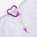Metallic purple heart-shaped carabiner keychain with heart beads on white fur background - Purple