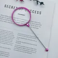 Metallic pink DIY beadable magnifying glass with 3x zoom over reading book. - Electroplated Pink
