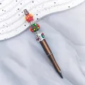 Handcrafted Christmas themed beaded ballpoint pen with gingerbread man and tree design - Pearlescent Camel-Gingerbread Man (Zhishi Culture Christmas Magic Wand) / 1.0mm Bullet Tip