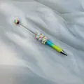 Handmade beadable pen with macaron heart charms and a blue-yellow gradient barrel - Purple Blue Yellow Gradient