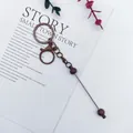 Elegant bronze lacquer lobster clasp keychain with decorative beads on a metal rod - 1 Piece / Coffee