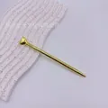 Elegant golden metal ballpoint pen featuring a decorative heart shaped top ornament - Gold Plating