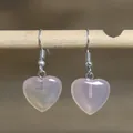 Pink rose quartz heart-shaped dangle earrings displayed on a natural wooden twig - Heart Style 21 (Rose Quartz)
