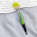 Green stylus ballpoint pen featuring a yellow mop-top doll head with a smiley face - 1.0mm Bullet Tip / Green