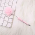 Cute pink fluffy pom pom ballpoint pen presented on a white keyboard and fur rug - Candy Light Pink