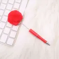 Adorable red ballpoint pen with a large fluffy plush pom-pom top on a white aesthetic desk - Bright Red