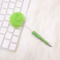 Cute bright green pom-pom ballpoint pen on white keyboard - Green