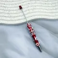 Creative handcrafted red ballpoint pen with white cream glue and floral charms decoration - Red