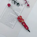 Luxury handmade ballpoint pen featuring red rhinestones with rose and butterfly motifs. - Red