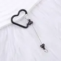 Black heart carabiner keychain with beaded charm on white fur background - Black