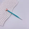 Elegant ballpoint pen featuring a rose gold heart-shaped top and teal gradient metal barrel - Gradient Blue