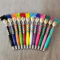 Set di 12 penne a sfera colorate con testa di bambola e pennino capacitivo touch integrato - Multicolore