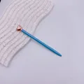 Elegant light blue ballpoint pen with a rose gold heart topper, perfect for gift-giving. - Blue