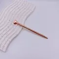Elegant rose gold metal ballpoint pen featuring a decorative heart-shaped top ornament - Rose Gold