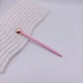 Elegant pink ballpoint pen with a rose gold heart topper, perfect for business gifts. - Candy Pink