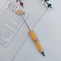 Handmade orange beaded ballpoint pen featuring sparkling sun moon and star rhinestones - Orange