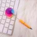 Creative ballpoint pen featuring a vibrant rainbow pom-pom top and sleek orange barrel - Rainbow Ball