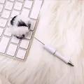 Cute panda-style pom-pom ballpoint pen with white barrel on soft fur background - Panda White