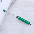 Metallic green DIY laser pointer and teacher's stick on soft white texture background - Green