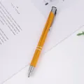 Professional executive metal ballpoint pen in orange-gold finish with premium silver accents - Orange