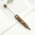 Elegant DIY beaded ballpoint pen with gold rhinestones and white daisy floral motifs - 1.0mm Bullet Tip / Light gold