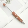 Pink DIY beadable ballpoint pen featuring daisy floral motifs and sparkling texture detail - 1.0mm Bullet Tip / Orange