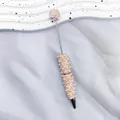 Eleganter Perlen-Kugelschreiber verziert mit glänzenden rosa Strasssteinen und Perlen - 1,0mm Kugelkopf / Champagner