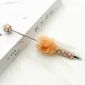 Elegant ballpoint pen with orange fuzzy pom-pom decorative pearls and sparkling rhinestones - Orange