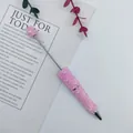 Elegant pink beaded ballpoint pen featuring heart patterns and shimmering crystal accents - 1.0mm Bullet Tip / Pink