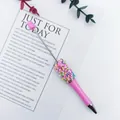 Detail view of a pink DIY beadable pen with colorful sprinkle beads on white background. - 1.0mm Bullet Tip / Macaron Pink