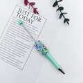 Detail view of a mint green ballpoint pen decorated with candy sprinkle beads - 1.0mm Bullet Tip / Khaki Light Green