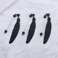 Black feather-shaped bead sticks for DIY bookmarks with heart star butterfly tops on white fur - Black
