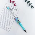 Blue beaded ballpoint pen featuring vibrant rainbow sprinkle decorations. - 1.0mm Bullet Tip / Candy Light Blue