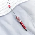 Elegant red metallic DIY pearl beaded ballpoint pen featuring white pearl accents. - 1.0mm Bullet Tip / UV Red
