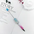 Elegant pearl beadable ballpoint pen with pink gradient and shiny rhinestone accents. - 1.0mm Bullet Tip / Blue White Purple