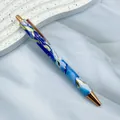 Elegant metal ballpoint pen featuring a blue marble pattern with rose gold trim accents - 1.0mm Bullet Tip / Gilded Light Blue