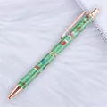 Green glitter Christmas ballpoint pen with rose gold metal accents on white faux fur background - Christmas Green (Rose Gold Parts)