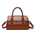 Vintage brown faux leather handbag featuring a unique braided handle and gold metal clasp - Yellow