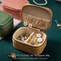 Detailed macro view of the interior compartments of a mini crocodile pattern jewelry box. - Light Orange Large (PU)