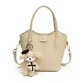 Stylish cream beige pebbled leather bucket bag featuring a cute teddy bear charm accessory - Bag Only (No Charm) / White