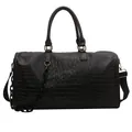 Macro view of black crocodile embossed leather travel duffle bag with chain detail - Black