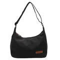Minimalist black canvas crossbody messenger bag with adjustable strap and leather patch - Black
