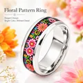 Macro detail of a polished stainless steel ring featuring a vibrant floral pattern inlay - Size 6 / Red Flower