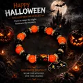 Close-up of Halloween beaded bracelet with bat charm and spooky pumpkin barrel bead. - Bat Charm Style