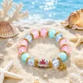 Ocean themed beaded bracelet featuring an octopus charm and pink crackle glass beads - Octopus