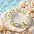 Mythical Ocean DIY bracelet featuring green cracked glass beads and gold dolphin charm - Dolphin