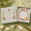 Elegant handmade beaded elastic bracelet with robin bird charm and branded gift box detail - Robin Style / Color Box Packaging