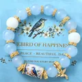 Handmade hummingbird beaded elastic bracelet with light blue beads and golden accents - Blue Bird Style / With Card / Blue
