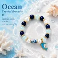 Mythical Ocean themed DIY beaded bracelet featuring blue crystals and a dolphin charm - Blue Whale