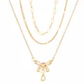 Collier doré à trois rangs avec nœud en zircone et pendentif lettre D élégant - Triple Rangée Superposée / Nœud Papillon Lettre D